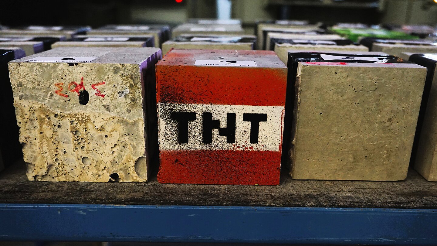 Betonwürfel rot angemalt mit Druckbuchstaben TNT